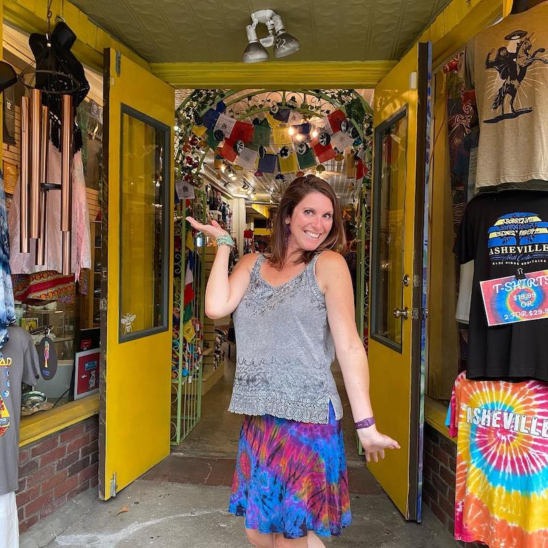 customer posing with new clothes bought from Instant Karma in Asheville, NC